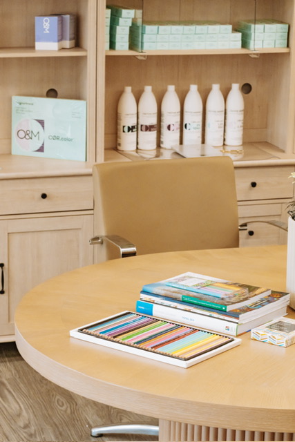 The Renovaré table beside the shelved O&M color line