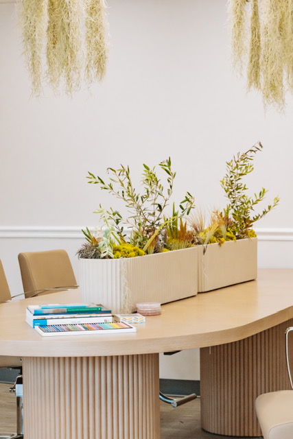 The relaxation table at Renovaré, set with olive greenery, books and coloring pencils
