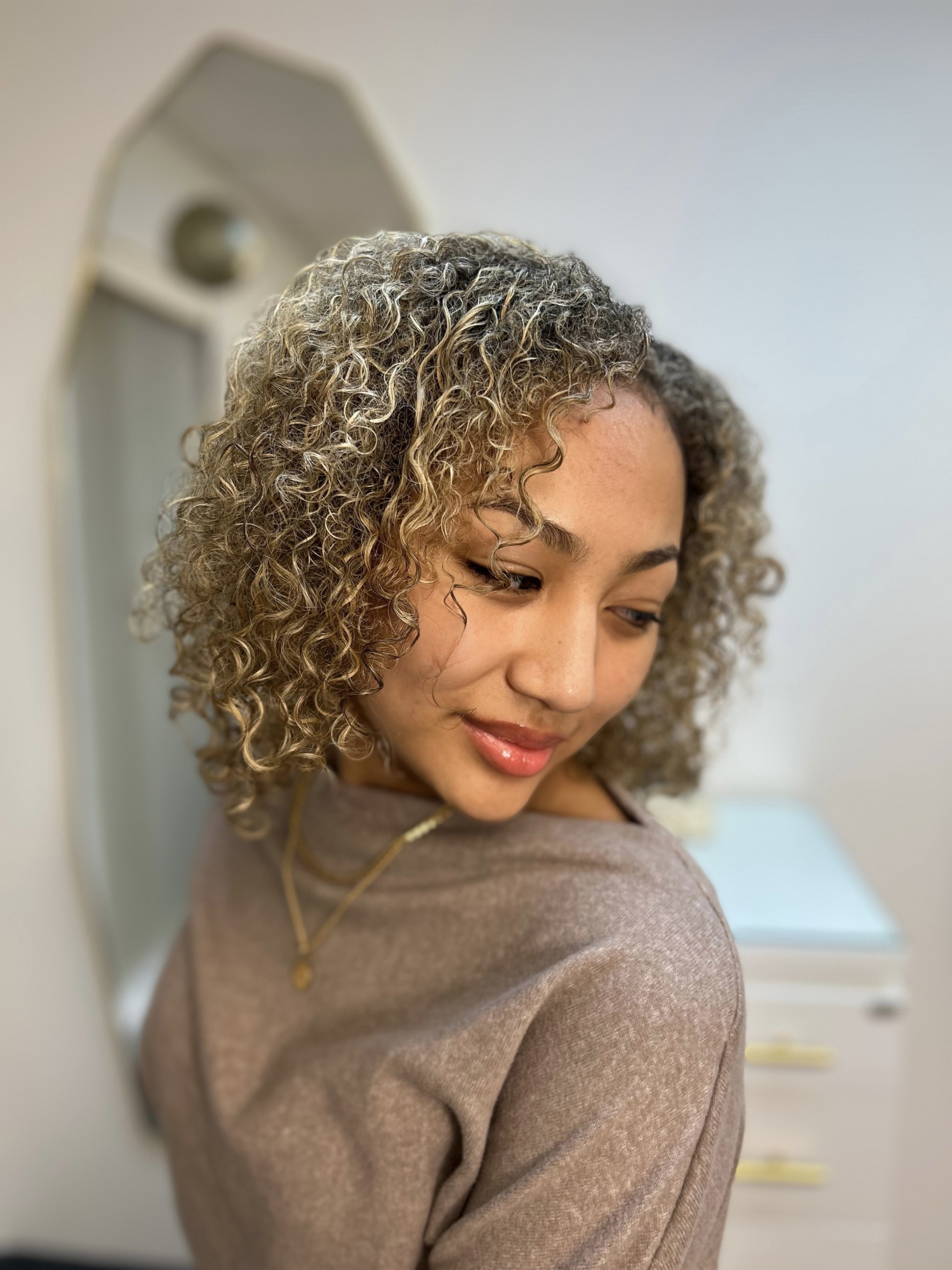 Curly bronde styling by Renovaré